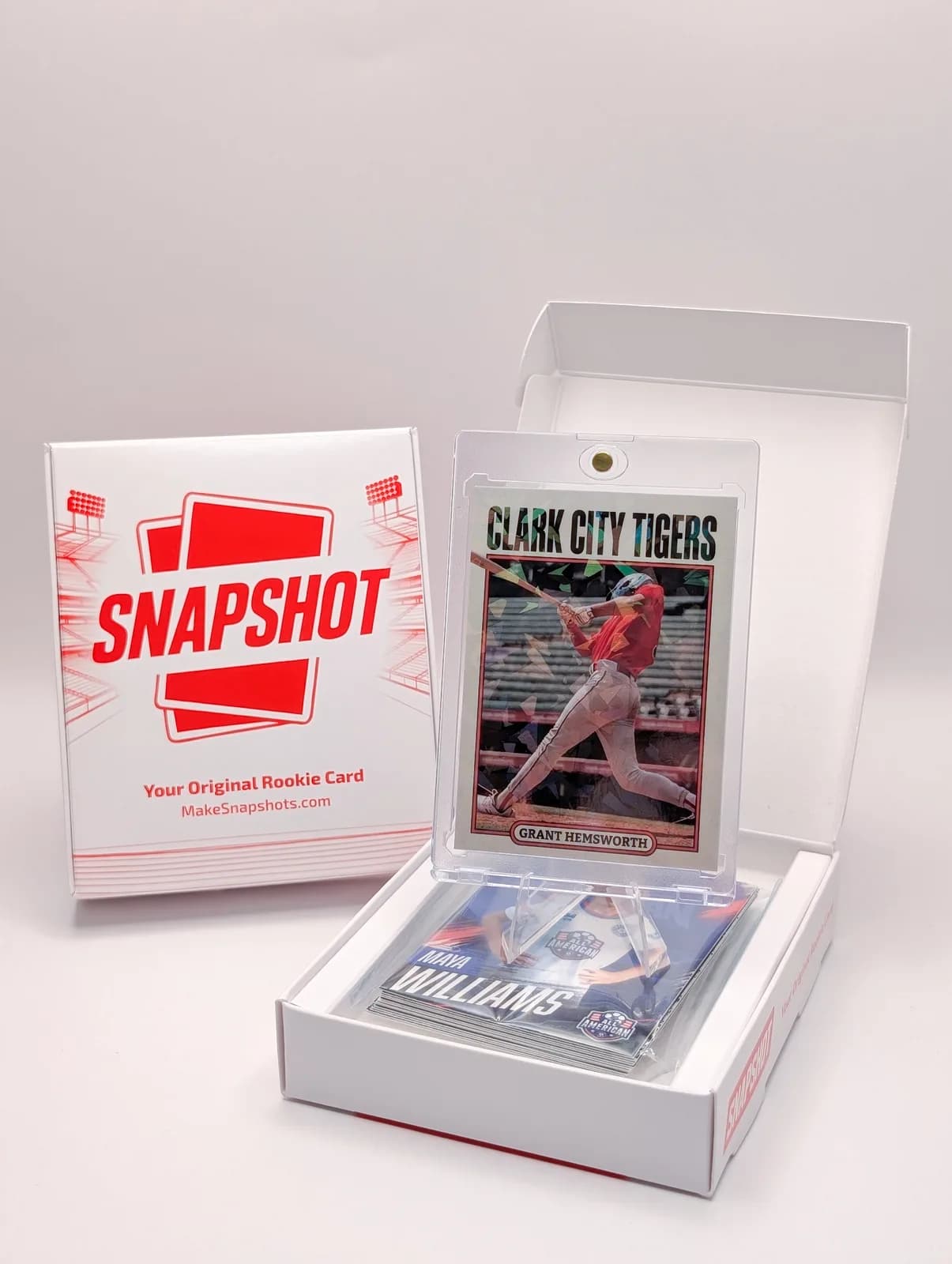 Open Snapshot Rookie Box with printed baseball cards and one card in a clear display case